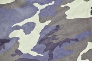 Texture of fabric with a camouflage painted in colors of the marsh. Army background image photo