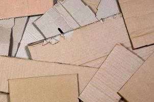 Background image with a lot of beige cardboard paper, which is used to make boxes for the transport of home appliances and postal parcels. Carton texture photo