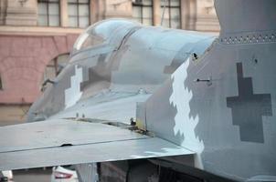 Old fighter aircraft painted in grey camouflage shapes with many rivets photo