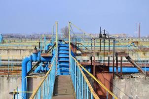 Industrial space with lots of pipes and communications photo