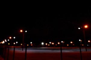 Blurred photo of school playground at night with bright lights