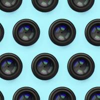 A few camera lenses with a closed aperture lie on texture background of fashion pastel blue color paper photo