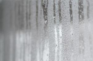 The texture of a misted glass with a lot of drops and condensation flows. Background image photo
