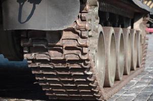 Close up of green armoured caterpillar transport. Modern military transportation vehicle technologies photo