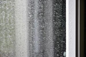 Background image of rain drops on a glass window. Macro photo with shallow depth of field