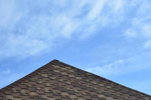 The roof covered with a modern flat bituminous waterproof coating under a blue sky photo