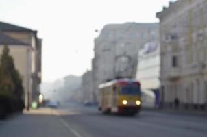 Blurred landscape of highway with cars and tram in foggy morning photo