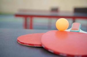 rackets and ball on Ping pong table in outdoor sport yard. Active sports and physical training concept photo