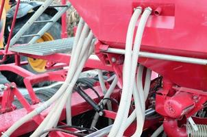 Springs and tubes are arranged in a row. A row of seeder. Heavy equipment on agricultural exhibition photo