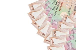 5000 Indonesian rupiah bills lies isolated on white background with copy space. Rich life conceptual background photo