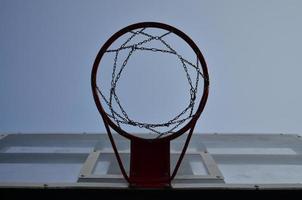 Outdoor Basketball backboard with clear blue sky photo