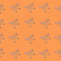 Shopping addiction, shopping lover or shopaholic concept. Many small empty shopping carts perform a pattern on a pastel colored paper background. Flat lay composition, top view photo