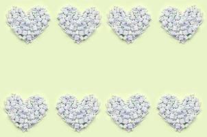 Colorful marshmallow laid out on lime and pink paper background. pastel creative textured hearts photo