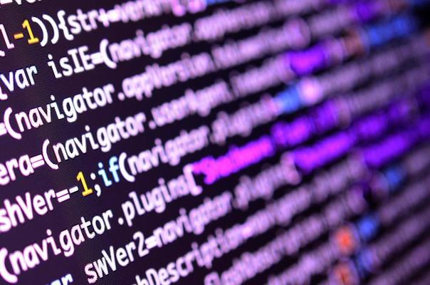 Macro shot of the command line on the monitor of the office computer. The concept of the programmer's work. Information line flow