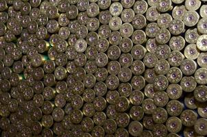 Pattern of 12 gauge cartridges for shotgun bullets. Shells for hunting rifle close up. Backdrop for shooting range or ammunition trade concepts photo