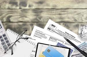 IRS form 8822 Change of Address lies on flat lay office table and ready to fill. U.S. Internal revenue services paperwork concept. Time to pay taxes in United States photo