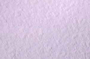 Texture of thick paper intended for watercolor painting. Macro snapshot of details of the relief paper structure photo