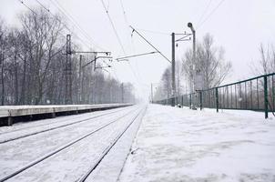 Railway station in the winter snowstorm photo