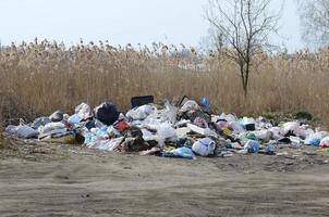 The garbage can is packed with garbage and waste. Untimely removal of garbage in populated areas photo