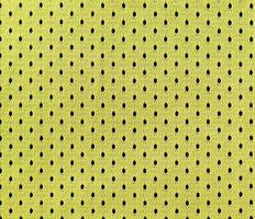 Close up of yellow polyester nylon yellow sportswear shorts to created a textured background photo