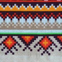 Traditional Ukrainian folk art knitted embroidery pattern on textile fabric photo