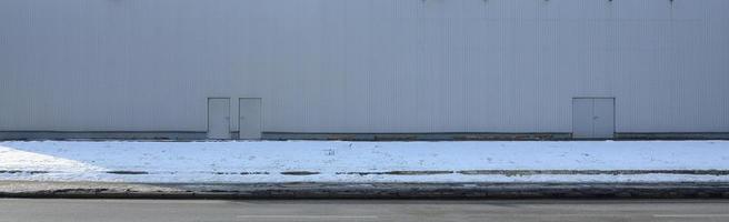 Texture of a high metal wall of an industrial building without windows photo