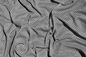 Close up of grey polyester nylon sportswear shorts to created a textured background photo