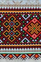 Traditional Ukrainian folk art knitted embroidery pattern on textile fabric photo