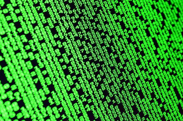 Macro of password selection on the monitor of the office computer. The concept of hacking the protection of a personal data keeper. The stream of supposed digital passwords of four and five digits