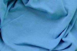 The texture of the fabric in blue color. Material for making shirts and blouses photo