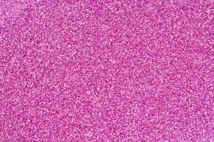 Pink decorative sequins. Background image with shiny bokeh lights from small elements photo