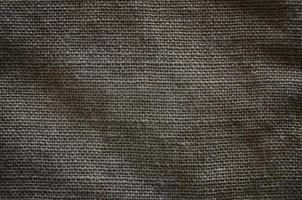 The texture of a very old brown sack cloth. Retro texture with canvas material. Background image with copy space photo