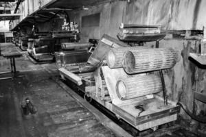 Large metal rollers rolls with teeth of the gears of the production line, a conveyor belt in the workshop at an industrial chemical petrochemical machine-building refinery with equipment machines photo