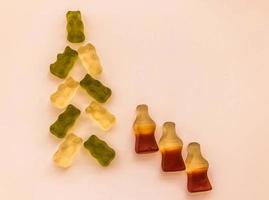 Christmas tree made of white and green gummy bears. Christmas Eve. gelatinous lemonade bottles are under the Christmas tree. delicious and appetizing dessert for the new year photo