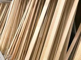 Texture of wooden brown diagonally tilted natural building boards sticks with knots. The background photo