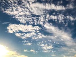 blue sky with white clouds on a clear sunny day. a piece of the watercolor sky is visible on the roof. clear and bright clouds. the ozone layer for people photo