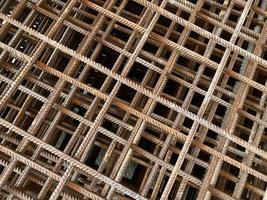 Iron rusty bars of wire reinforcement for building houses and producing industrial reinforced concrete at a construction site photo