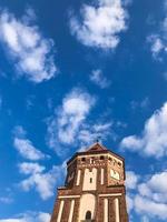 Towers and spiers of a high medieval stone old ancient beautiful castle against a blue sky photo