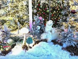 New Year's decorations for the shopping center. artificial Christmas trees with lighting. next to them are cute polar bears. artificial animals celebrate new year photo