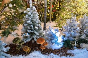 Beautiful festive arrangement of fresh spruce with ball toys in a rustic wooden box. Christmas mood. Bokeh of Garland lights on background photo