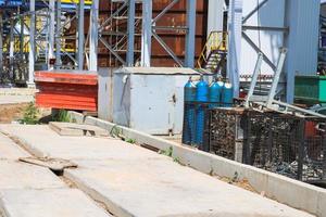 Blue iron metal cylinders with liquefied gas oxygen oxygen air helium argon for welding at the refinery petrochemical plant photo