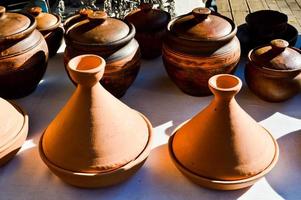 Natural traditional clay pottery beautiful old kitchen appliances, dishes, jugs, vases, pots, mugs. The background photo