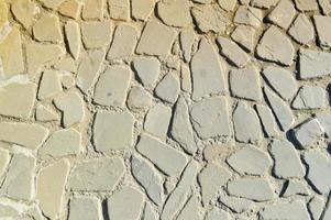 la textura del camino de piedra, pavimento, paredes de grandes piedras grises redondas medievales antiguas, adoquines. el fondo foto