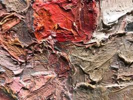 bright, multicolored texture with a red spot in the center. acrylic paint on canvas. palette, stains of paint mixed with water. the texture is heterogeneous, voluminous. the background photo