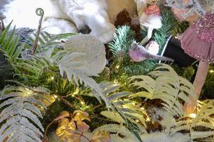 Close-Up Of Illuminated Lights On Snow Covered Leaves At Night During Christmas photo