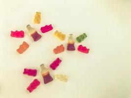 gummy candy on a white matte background. marmalade is laid out in the form of butterflies. gummy bears and lemonade bottles. Flora and fauna. gelatinous animal world photo
