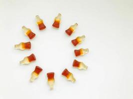 marmalade candies. sweets in the form of a bottle with lemonade. chewing gummy lies in the shape of a circle, sun. rays of the sun from sweets photo