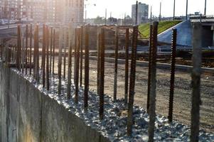 rusty pins sticking out of concrete blocks. laying of blocks for the construction of a new building. block technology for manufacturing houses. concrete structures to create a residential complex photo