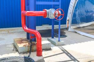 Iron red metal pipe with valve and flanges and drainage for emergency fire fighting at the factory. Fire crane photo