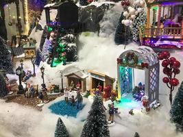 New Year's landscape. toy miniature for the showcase. cute showcase, hand made composition. in the center is an unusual white wicker gazebo. next to her is a berry tree with round fruits photo